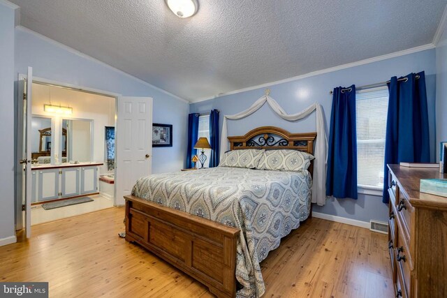 400 Fork River Rd N, Shenandoah, VA 22849 - bedroom featuring ornamental molding, light wood-style floors, vaulted ceiling, a textured ceiling, and ensuite bathroom