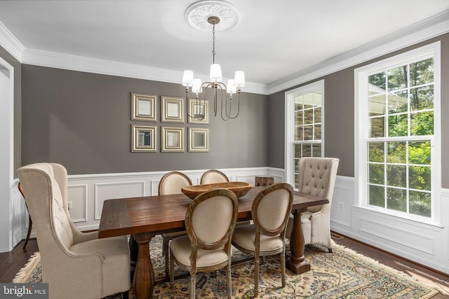 11219 Kailee Ln, Spotsylvania, VA 22553 - dining area with a chandelier, crown molding, wood finished floors, a decorative wall, and wainscoting
