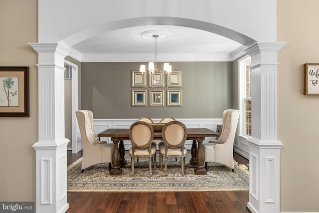11219 Kailee Ln, Spotsylvania, VA 22553 - dining area with arched walkways, decorative columns, dark wood-style flooring, a chandelier, and crown molding