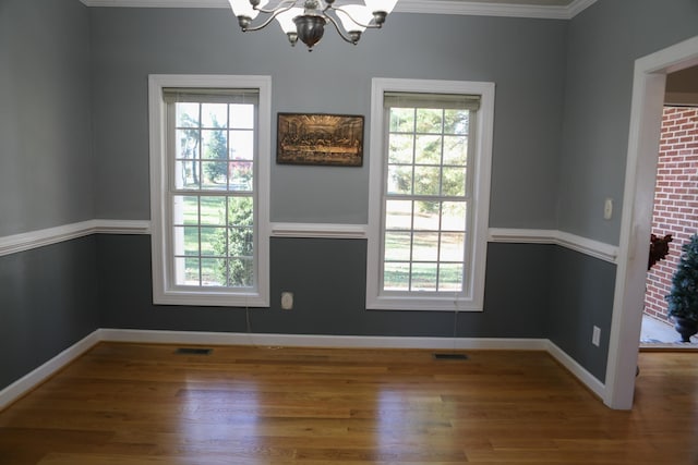 182 Henkel Rd, Waynesboro, VA 22980 - unfurnished dining area with a chandelier, wood finished floors, healthy amount of natural light, crown molding, and baseboards