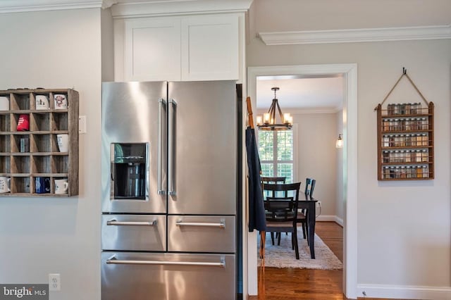 52 N St, Warrenton, VA 20186 - kitchen with stainless steel fridge, crown molding, dark wood finished floors, white cabinets, and a chandelier