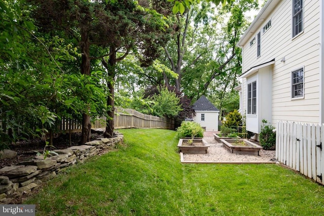 52 N St, Warrenton, VA 20186 - view of yard featuring a vegetable garden and an outbuilding