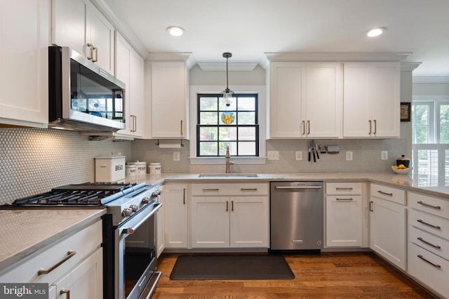 52 N St, Warrenton, VA 20186 - kitchen featuring appliances with stainless steel finishes, a sink, crown molding, white cabinetry, and wood finished floors