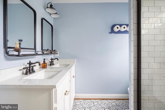 52 N St, Warrenton, VA 20186 - bathroom featuring double vanity, toilet, baseboards, and a tile shower