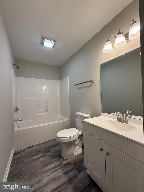 319 Chopping Rd, Mineral, VA 23117 - full bathroom with wood finished floors, vanity, and tub / shower combination