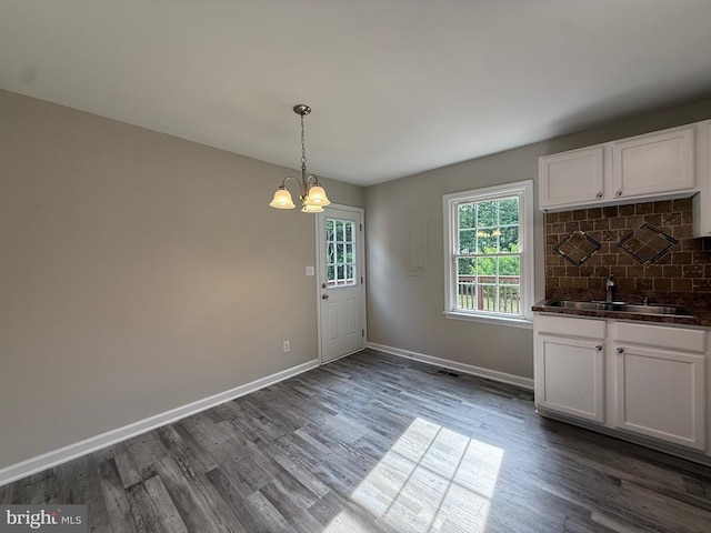 319 Chopping Rd, Mineral, VA 23117 - unfurnished dining area with a chandelier, dark wood finished floors, and bar with sink