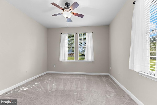  - carpeted empty room with baseboards and ceiling fan