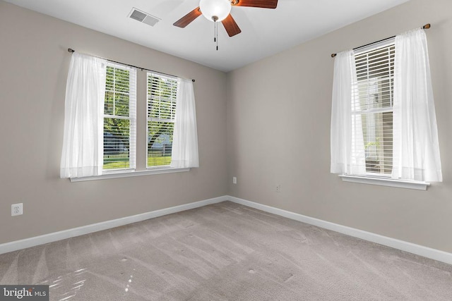  - carpeted empty room featuring a ceiling fan and baseboards