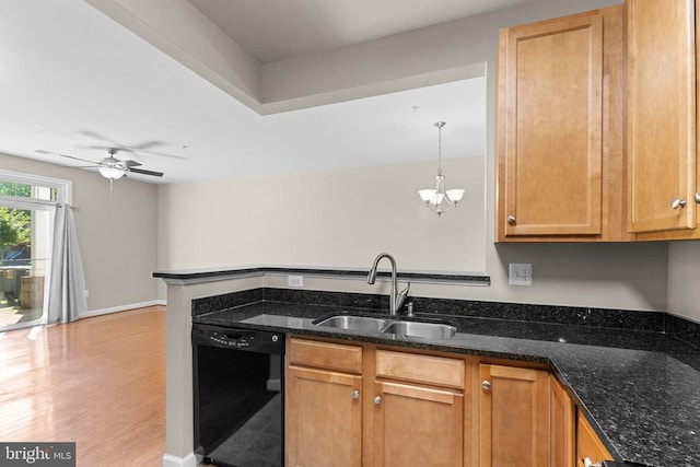  - kitchen with black dishwasher, a chandelier, dark stone counters, a peninsula, and light wood-style floors