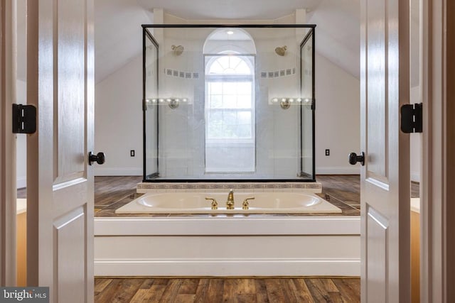 369 Eldon Yates Dr, Stanley, VA 22851 - bathroom featuring vaulted ceiling, a bath, a stall shower, and wood finished floors