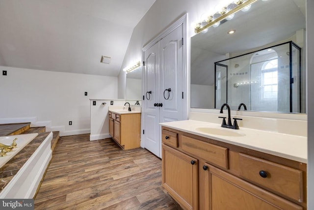 369 Eldon Yates Dr, Stanley, VA 22851 - full bath featuring vaulted ceiling, a stall shower, two vanities, wood finished floors, and a garden tub