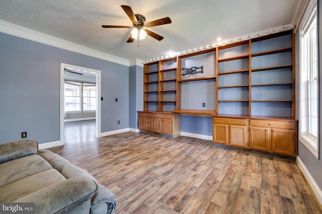 369 Eldon Yates Dr, Stanley, VA 22851 - living room featuring built in study area, light wood finished floors, ornamental molding, a ceiling fan, and a textured ceiling