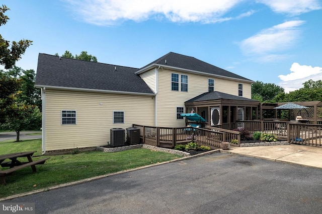 369 Eldon Yates Dr, Stanley, VA 22851 - rear view of house featuring a wooden deck, a yard, a patio, and roof with shingles