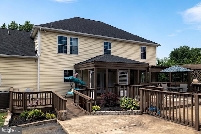 369 Eldon Yates Dr, Stanley, VA 22851 - rear view of property featuring a deck, roof with shingles, and a sunroom