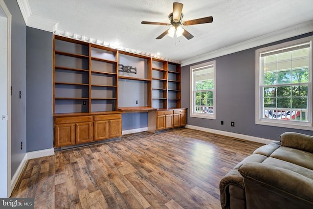 369 Eldon Yates Dr, Stanley, VA 22851 - home office featuring dark wood finished floors, ornamental molding, built in study area, ceiling fan, and a textured ceiling