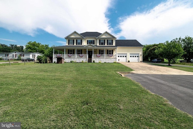 369 Eldon Yates Dr, Stanley, VA 22851 - view of front of property featuring a porch, driveway, an attached garage, and a front lawn