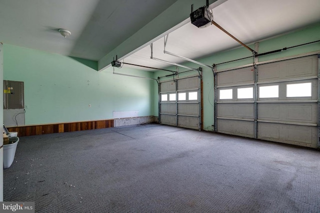 369 Eldon Yates Dr, Stanley, VA 22851 - garage with a garage door opener, electric panel, and a wainscoted wall