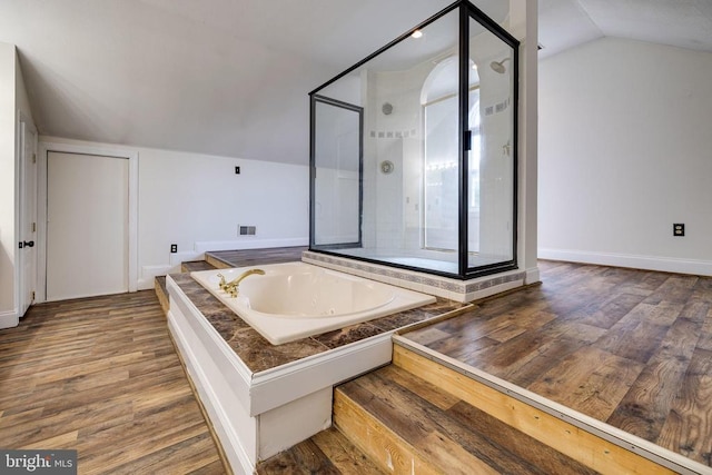 369 Eldon Yates Dr, Stanley, VA 22851 - bathroom featuring a garden tub, lofted ceiling, a shower stall, and wood finished floors