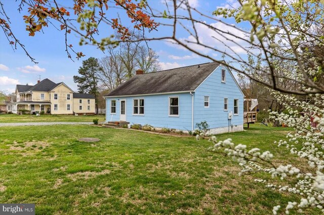 8952 Courthouse Rd, Spotsylvania, VA 22553 - view of property exterior with a chimney, a lawn, and roof with shingles
