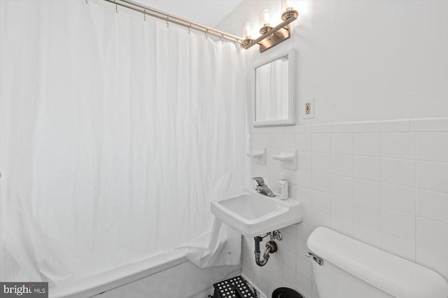 8952 Courthouse Rd, Spotsylvania, VA 22553 - bathroom with toilet, tile walls, shower / tub combo, and wainscoting