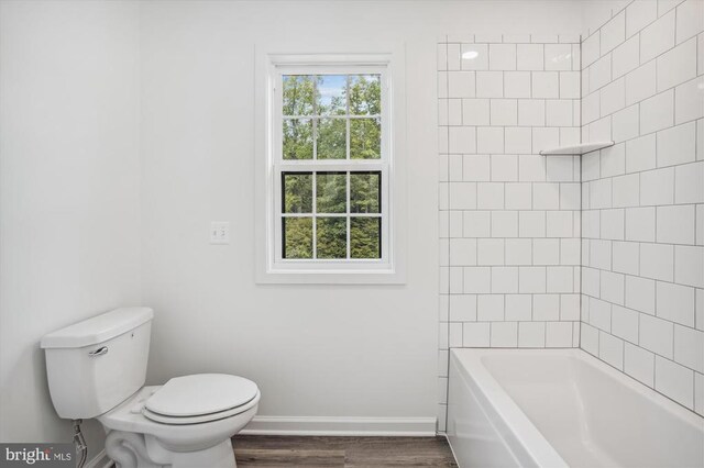  - full bathroom with baseboards, toilet, and wood finished floors