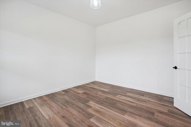  - spare room featuring wood finished floors and baseboards