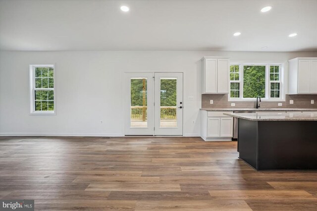  - kitchen with dishwasher, white cabinets, tasteful backsplash, light stone counters, and recessed lighting