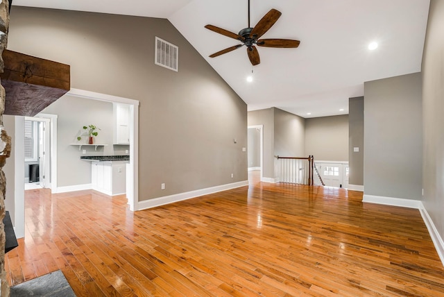 17 Mcilwee Ln, Staunton, VA 24401 - unfurnished living room featuring ceiling fan, high vaulted ceiling, wood finished floors, a large fireplace, and baseboards