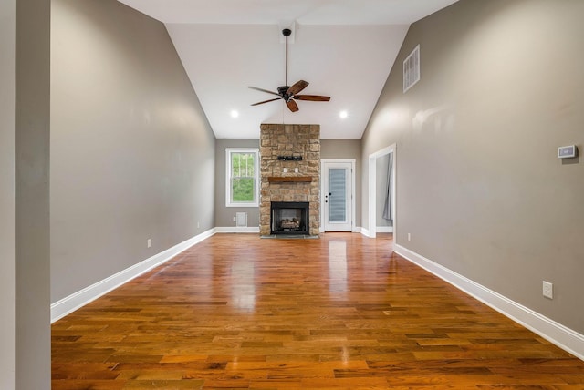 17 Mcilwee Ln, Staunton, VA 24401 - unfurnished living room with ceiling fan, wood finished floors, a stone fireplace, high vaulted ceiling, and baseboards