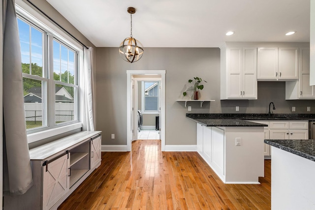 17 Mcilwee Ln, Staunton, VA 24401 - kitchen with open shelves, a chandelier, white cabinetry, light wood-style floors, and baseboards