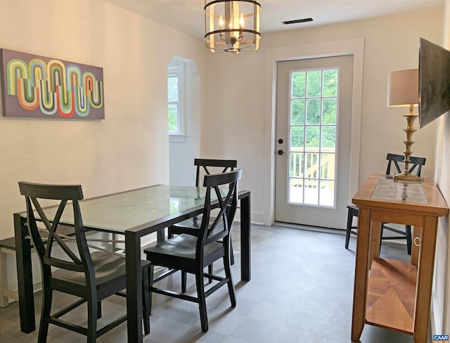 239 Shamrock Rd, Charlottesville, VA 22903 - dining area with arched walkways, healthy amount of natural light, a chandelier, and light floors