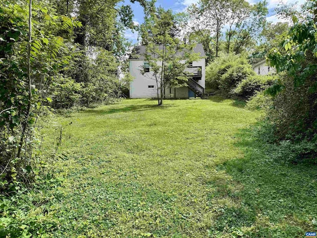 239 Shamrock Rd, Charlottesville, VA 22903 - view of green lawn with stairway and a wooden deck