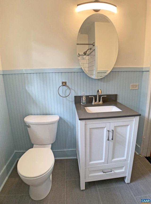 239 Shamrock Rd, Charlottesville, VA 22903 - bathroom with wainscoting, toilet, vanity, and tile patterned floors