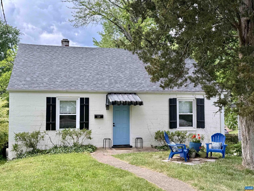 239 Shamrock Rd, Charlottesville, VA 22903 - view of front of home featuring a shingled roof, a chimney, a front lawn, and concrete block siding