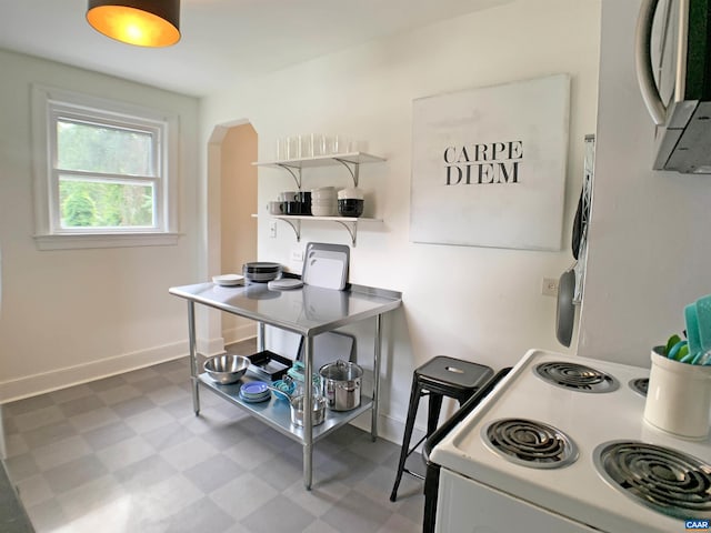 239 Shamrock Rd, Charlottesville, VA 22903 - kitchen featuring white range with electric stovetop, arched walkways, tile patterned floors, baseboards, and open shelves