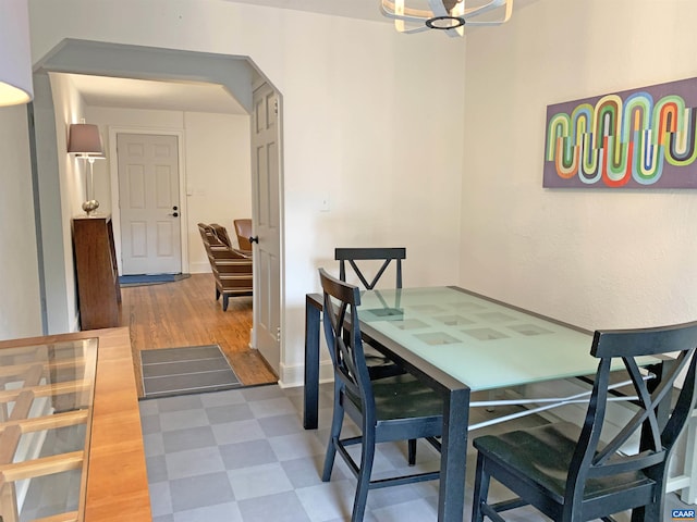 239 Shamrock Rd, Charlottesville, VA 22903 - dining area featuring tile patterned floors, a chandelier, and baseboards