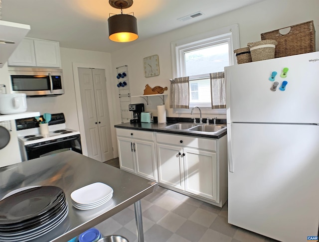 239 Shamrock Rd, Charlottesville, VA 22903 - kitchen featuring white appliances, a sink, light floors, and white cabinetry