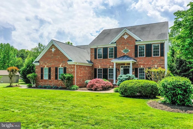 12400 Eustace Dr, Bumpass, VA 23024 - colonial inspired home featuring brick siding, a front yard, and a shingled roof