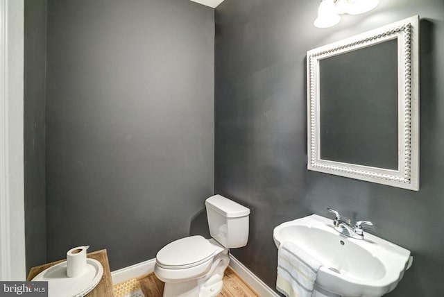 12400 Eustace Dr, Bumpass, VA 23024 - half bath featuring a sink, toilet, baseboards, and wood finished floors