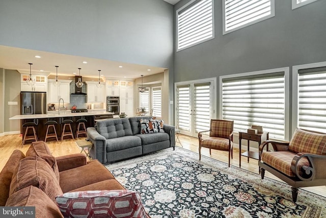 12400 Eustace Dr, Bumpass, VA 23024 - living room featuring light wood-style flooring, healthy amount of natural light, and a towering ceiling