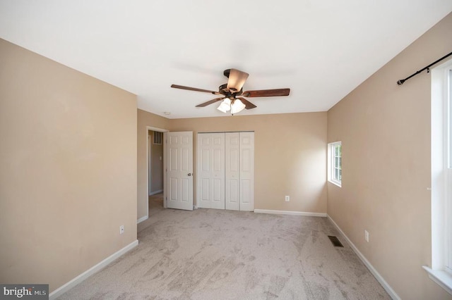  - unfurnished bedroom with carpet flooring, a closet, and ceiling fan