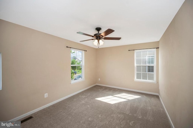  - empty room with carpet floors and ceiling fan
