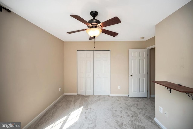  - unfurnished bedroom featuring light colored carpet, a closet, and ceiling fan