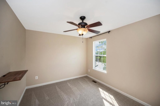  - unfurnished room featuring a ceiling fan and carpet