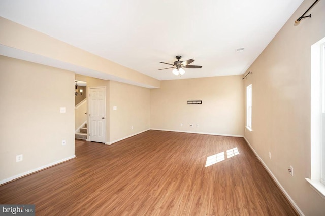  - spare room featuring a ceiling fan, stairway, and wood finished floors
