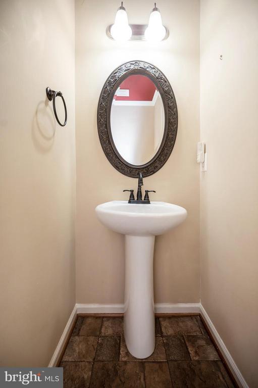 - bathroom featuring stone tile floors and baseboards