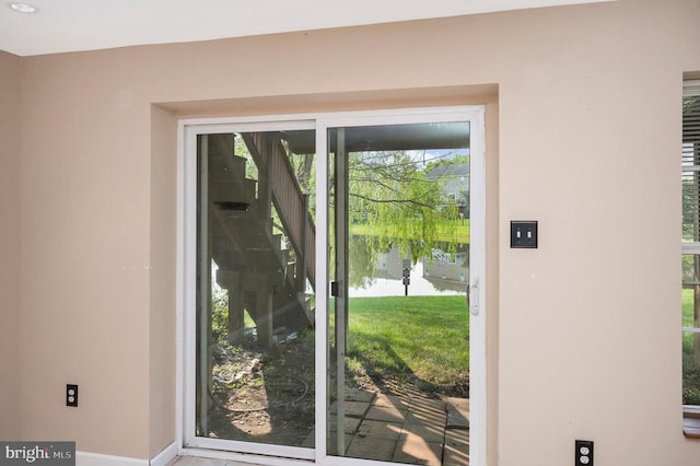  - doorway with baseboards and a water view