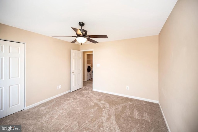  - unfurnished bedroom with carpet, washer / dryer, ceiling fan, and a closet