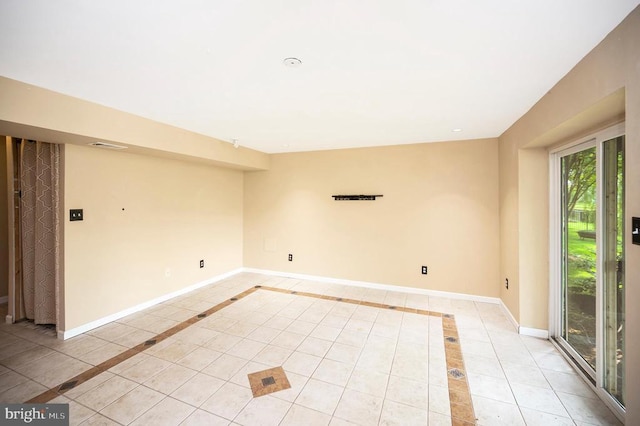  - empty room featuring light tile patterned floors
