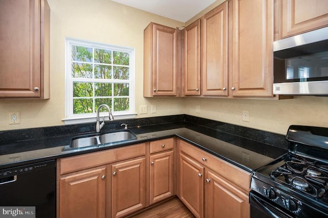  - kitchen featuring black appliances, dark stone countertops, and wood finished floors